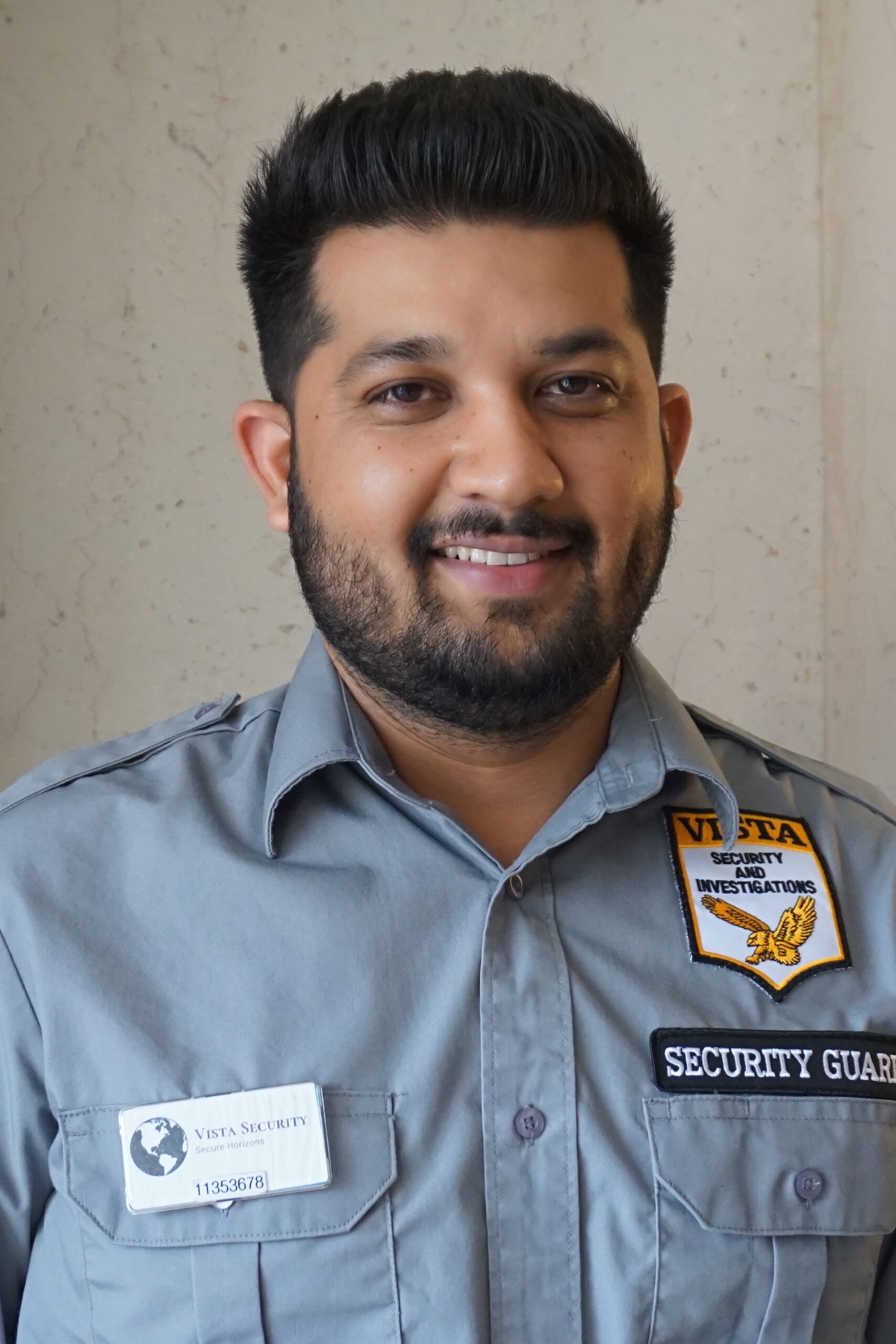 Vista featured employee Akshat standing in front of a window in uniform.
